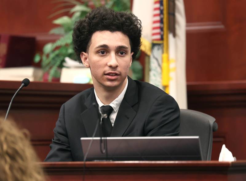 Hamza Khatatbeh, 17, formerly of Sycamore, looks at the jury as he testifies in his own defense Thursday, Feb. 19, 2026, during the second day of his murder trial at the DeKalb County Courthouse in Sycamore. Khatatbeh is accused of fatally stabbing Sycamore 17-year-old Kaleb McCall in 2023.