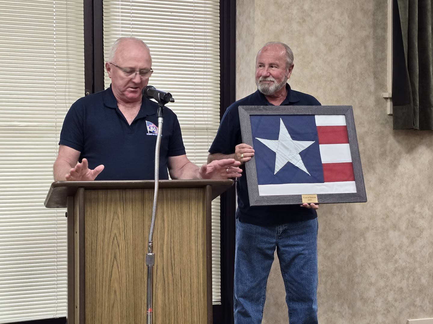 Rodney Johnson (left), chairman of the Flags of Freedom Committee, read the resolution Monday, April 8, 2025, to the Princeton City Council and Tom Root presented one of the stars from a former flag in a display case to the city.