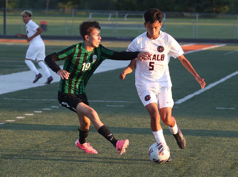 DeKalb's Brandon Cervantes pushes the ball up field against St. Edward's Omar Garcia Thursday, Aug. 28, 2025, during their game in the Barb Cup tournament at DeKalb High School.