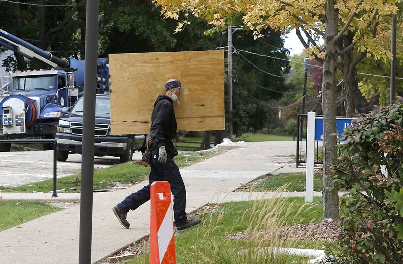 Windows are boarded up on Tuesday, October 10, 2023, after an explosion following a gas leak in the area leveled one home as caused several fires.