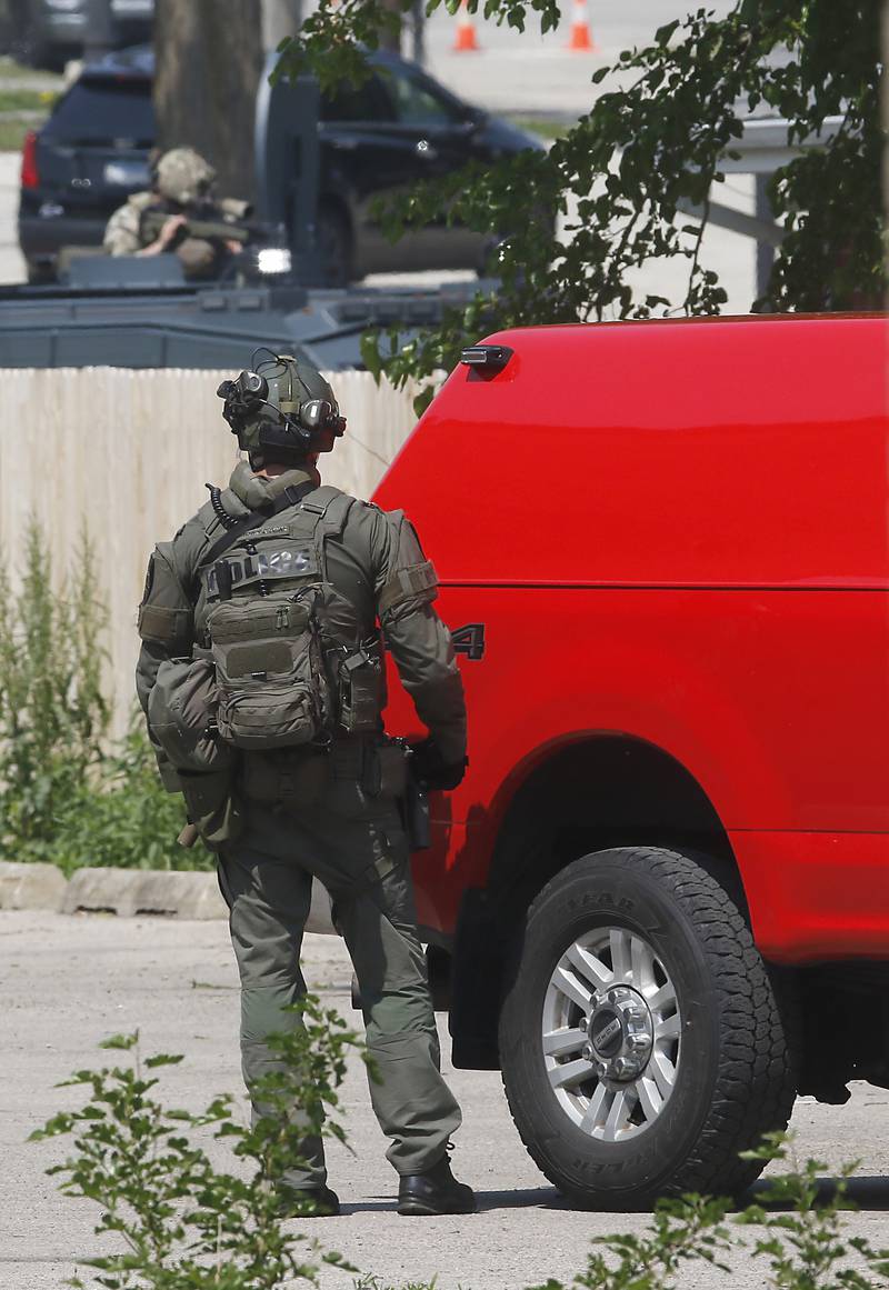 Law enforcement from area departments surround a home on Thursday, June 5, 2025, in the area of Venice Avenue and Court Street in McHenry.