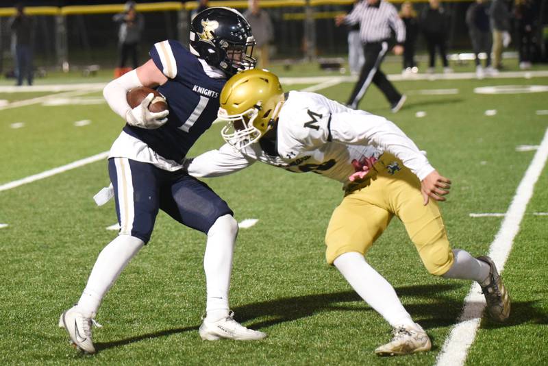 IC Catholic's Will Schmidt, left, evades a tackle attempt from Bishop McNamara's Coen Demack during an IHSA Class 3A second round playoff game at IC Catholic Friday, Nov. 7, 2025.