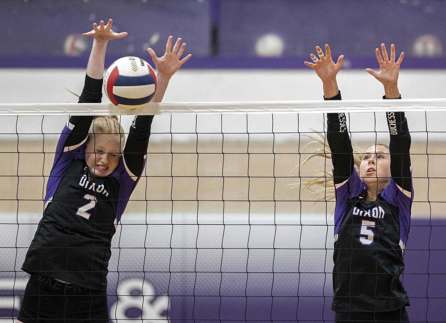 Dixon’s Madyson Tichler (left) and Morgan Hargrave blocks a shot against North Boone Tuesday, Sept. 24, 2024, in Dixon.