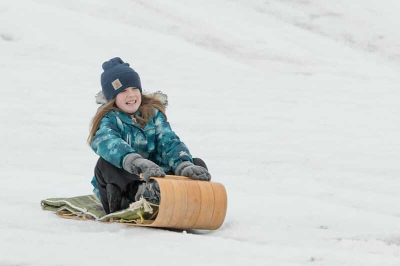 Alexandra Schwantes, 11 of DeKalb rides her toboggan down the sledding hill at Hopkins Park in DeKalb on Wednesday, Dec. 30, 2020.