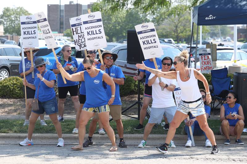 Nurses and supporters do a line dance to the music as they pickets outside Ascension Saint Joseph-Joliet hospital on Thursday, Aug. 24, 2023.