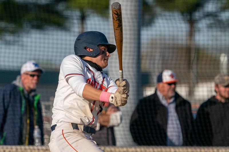 Oswego’s Benjamin Hernandez (10) hits a grounder against Minooka during a baseball game at Oswego High School on Tuesday, April 18, 2023.