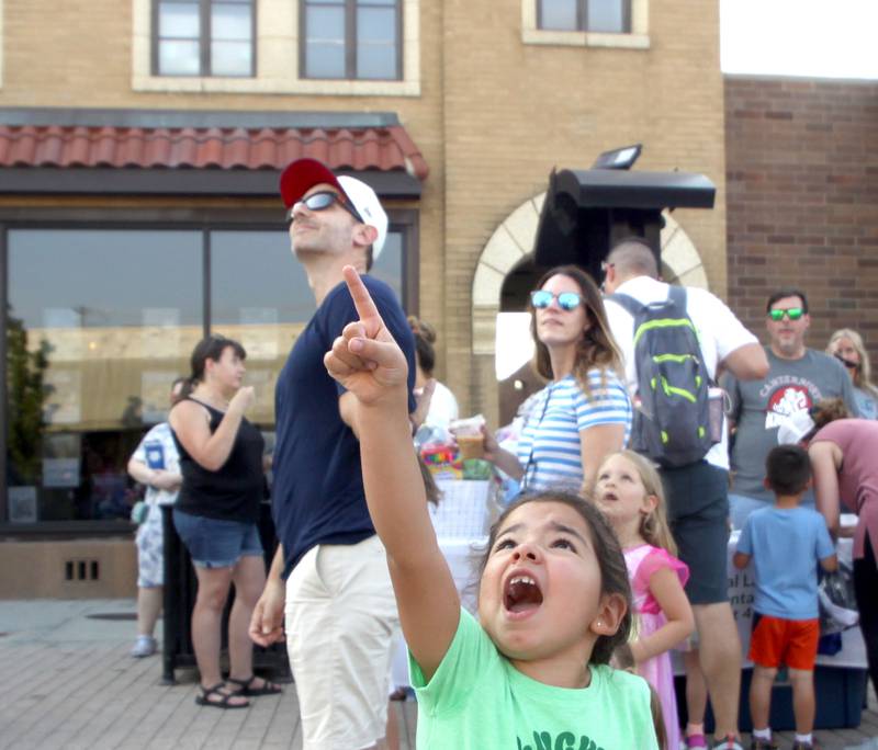 Zoe Arias, 5, of Huntley and others react as the Crystal Lake Police Department drone takes flight during National Night Out activities in downtown Crystal Lake on Thursday, Aug. 7, 2025.