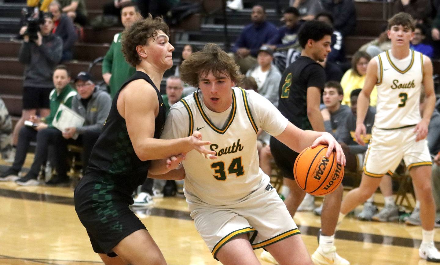 Crystal Lake South’s John Morgan works under the hoop as Waubonsie Valley’s Tyus Payne defends during Hinkle Holiday Classic varsity boys basketball tournament title game action on Friday, Dec. 27, 2024 at Jacobs High School in Algonquin.