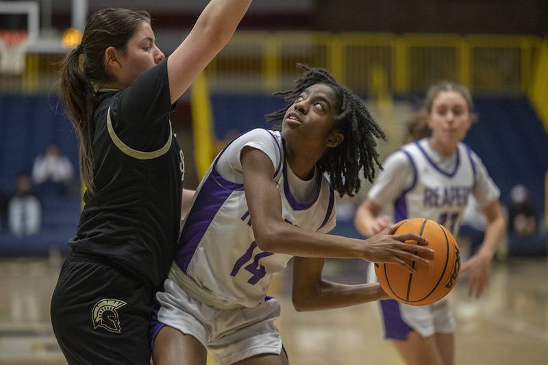 Plano’s Luniah Gilford works against Sycamore’s Norah Chami Monday, Feb. 17, 2025, during a 3A semifinal in Sterling.