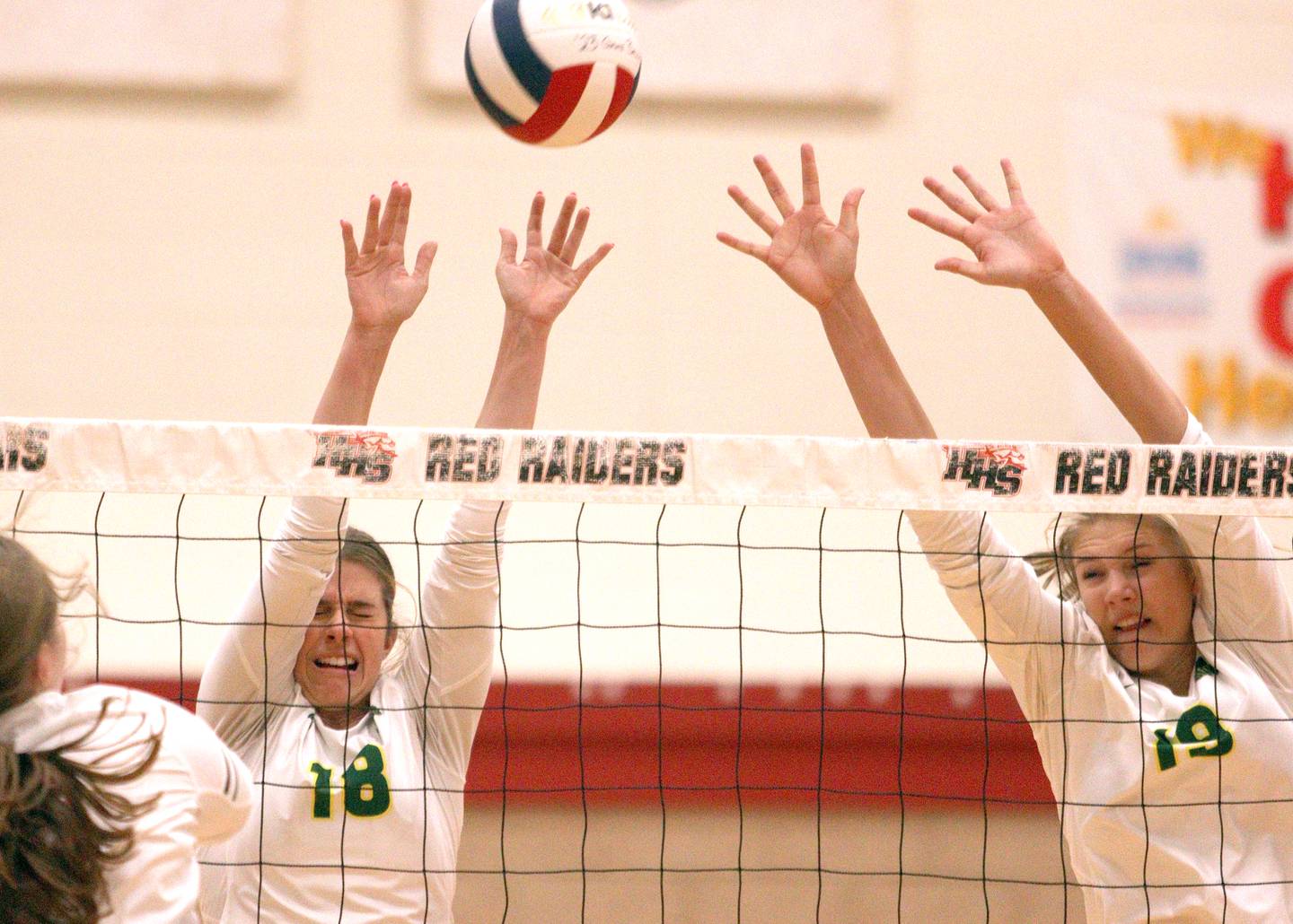 Crystal Lake South’s Grace Meyer, left, and Logan Georgy block in varsity volleyball at Huntley Tuesday.