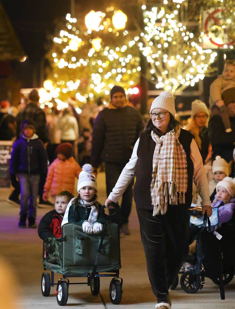 Visitors check out the windows as they walk down State Street Friday, Nov. 21, 2025, during Moonlight Magic in downtown Sycamore.