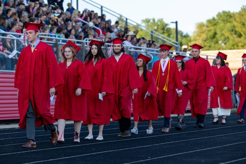 Graduates walk onto football field on Friday May 23, 2025 at Ottawa High School in Ottawa.