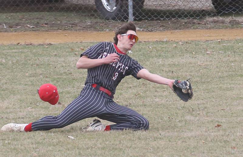 Hall's Jack Jablonski makes a diving catch in right field while playing Streator on Tuesday, March 18, 2025 in Foley Field at Kirby Park in Spring Valley.