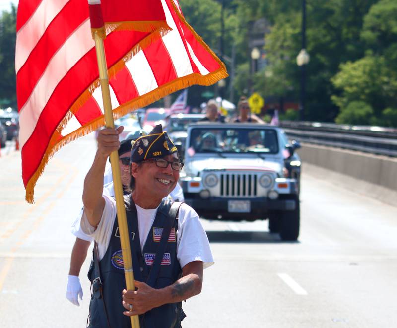 Paul Ninos of Chicago grins as he marches with American Legion Post 1231 members as part of the Founders’ Days parade along Route 62 in Algonquin Saturday. Ninos is a Navy veteran from the Gulf War.