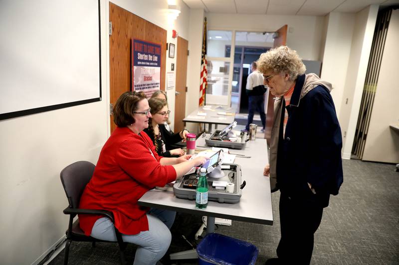 Election Judge Amy Cho assists Irene Hill of Elburn for the General Primary Election at the Town and Country Library polling place in Elburn on Tuesday, March 19, 2024.