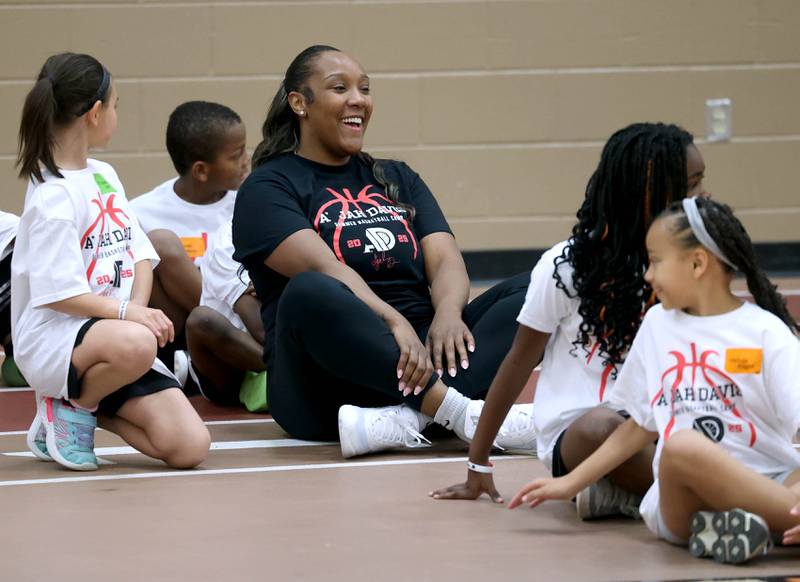 DeKalb native and former Northern Illinois University basketball player A'Jah Davis has a laugh with participants during a relay race Saturday, May 24, 2025, at her A'Jah Davis Foundation Basketball Camp and Wellness Day at DeKalb High School.