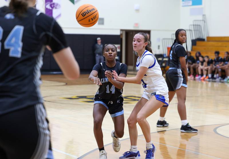 Kankakee's Jasyia Wesby passes as Rosary's Zoe Mesner defends during the Kays' 75-28 victory over Rosary at the Reed-Custer Classic on Monday, Nov. 17, 2025.