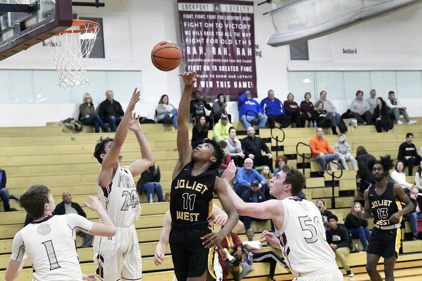Joliet West's Jeremy Fears Jr. gets a shot off surrounded by Lockport defenders on Tuesday at Lockport Township High School.