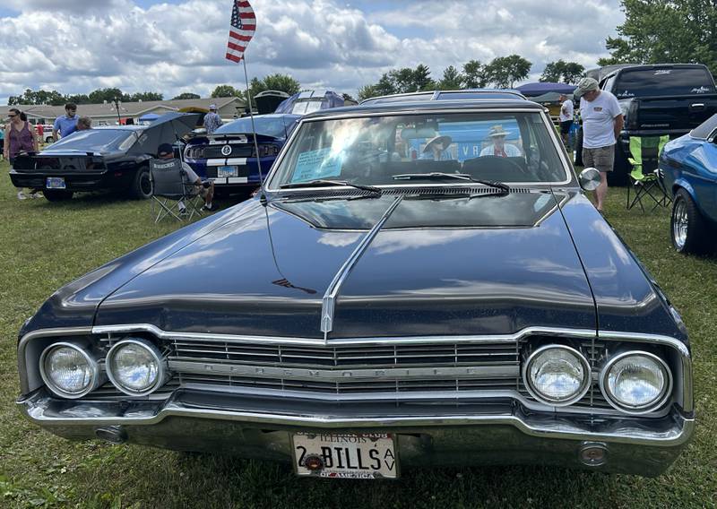 Bill and Joann Wagaman of Rockford chat with a visitor as they sit behind their 1965 Oldsmobile Vista Cruiser station wagon at the 34th Annual Hib Reber Memorial Car Show in Byron on Saturday, July 12, 2025.