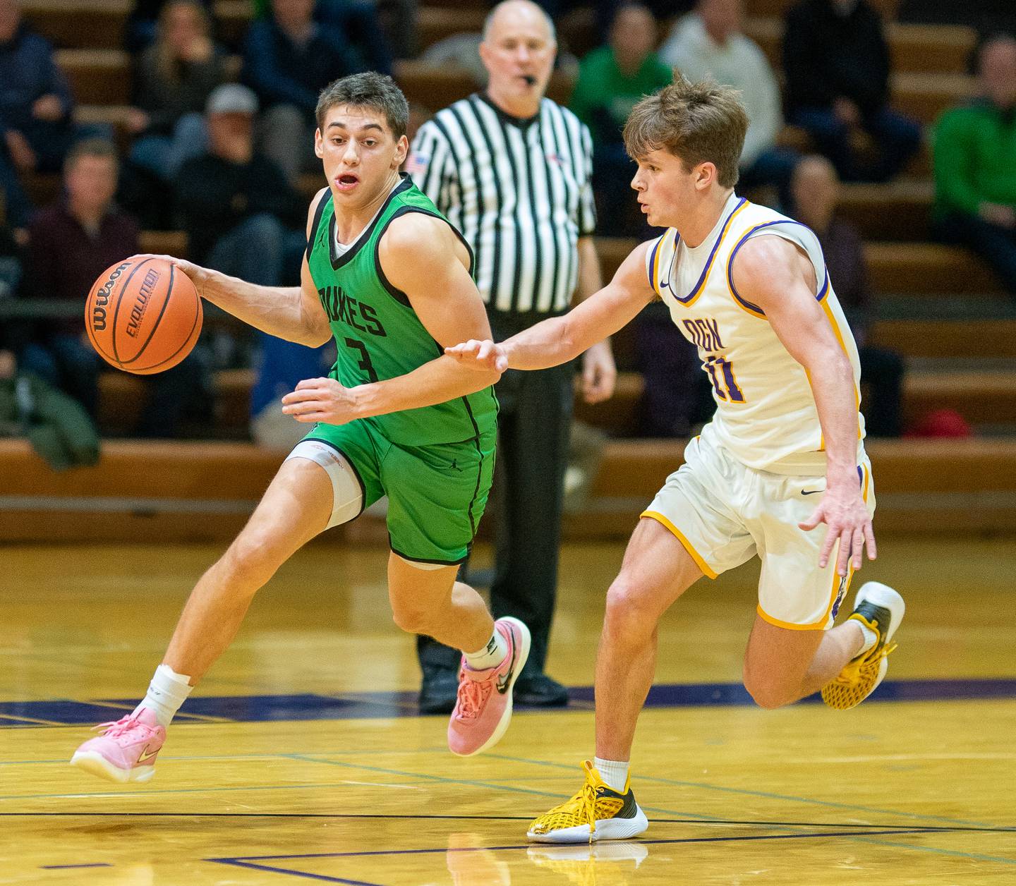 York's A.J. Levine (3) drives to the basket against Downers Grove North's Owen Thulin (11) during a basketball game at Downers Grove North High School on Friday, Dec 9, 2022.