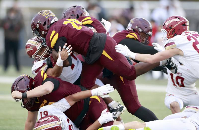Montini's Isaac Alexander (28) dives for a few extra yards during the IHSA Class 4A semifinals football playoff game Saturday, Nov. 22, 2025 in Lombard.