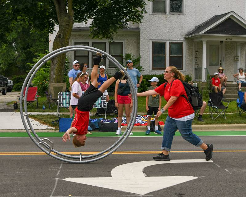 Cirques Experience rolls down Main Street with no hands during the Independence Day parade on Friday July 4, 2025, held in downtown Downers Grove.