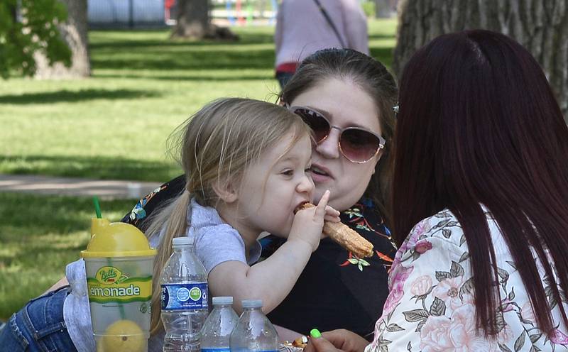 As her mother Kelly looks on, Sophie Duncan samples Mexican cuisine Saturday, May 20, 2023, at City Park in Streator during the Food Truck Festival.