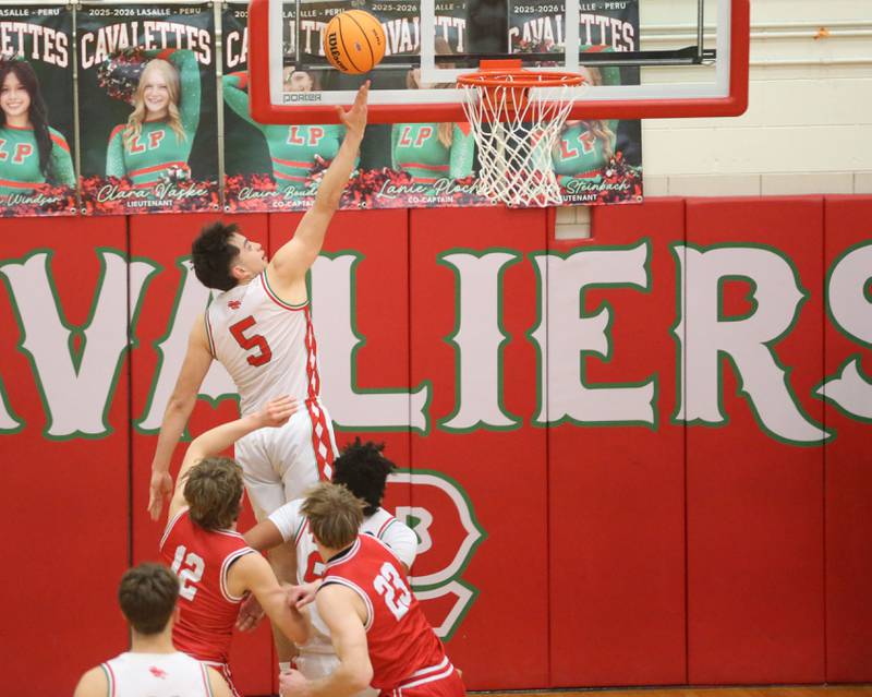 L-P'e Erick Sotelo scores on a layup over Ottawa's Jack Carroll and Owen Sanders during the Class 3A Regional title game on Wednesday, Feb. 25, 2026 in Sellett Gymnasium at L-P High School.