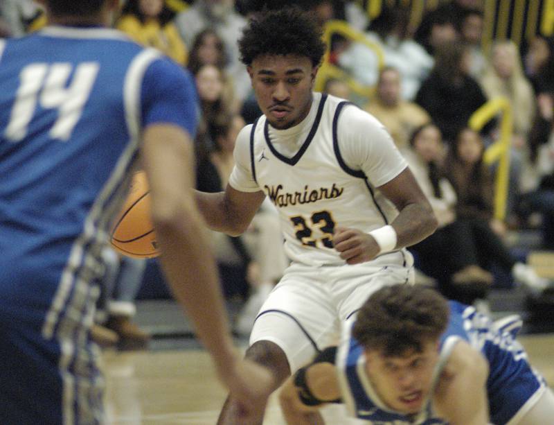 Sterling's Kaedon Phillips  brings the ball up court through Quincy defenders.  The action took place on Friday, December 13th at Sterling.