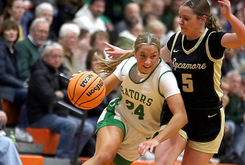 Crystal Lake South’s Gracey LePage, left, works past Sycamore’s Grace Amptmann in girls IHSA Class 3A Sectional basketball on Tuesday, Feb. 24, 2026, at Crystal Lake Central High School in Crystal Lake.