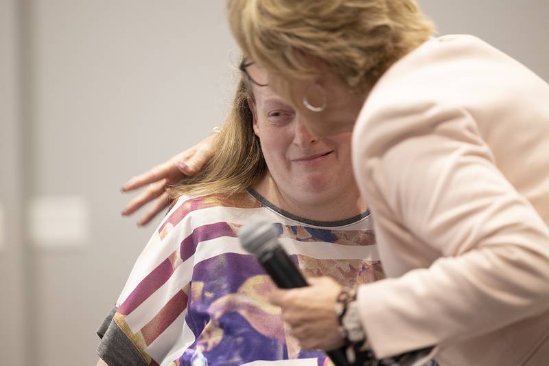 Jessica Abell gets a hug from Self Help Executive Director Pam Fluck Thursday, Oct. 17, 2024, after receiving the Carla Haubrich Leadership Award. Self Help held their annual client awards and staff recognitions