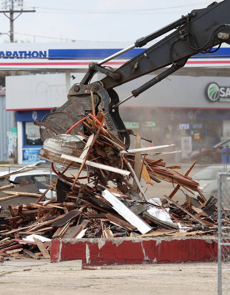 An excavator from Stark & Son clears debris Monday, April 28, 2025, after the former Illini Tire Co. building on the northeast corner West Lincoln Highway and Annie Glidden Road was torn down.