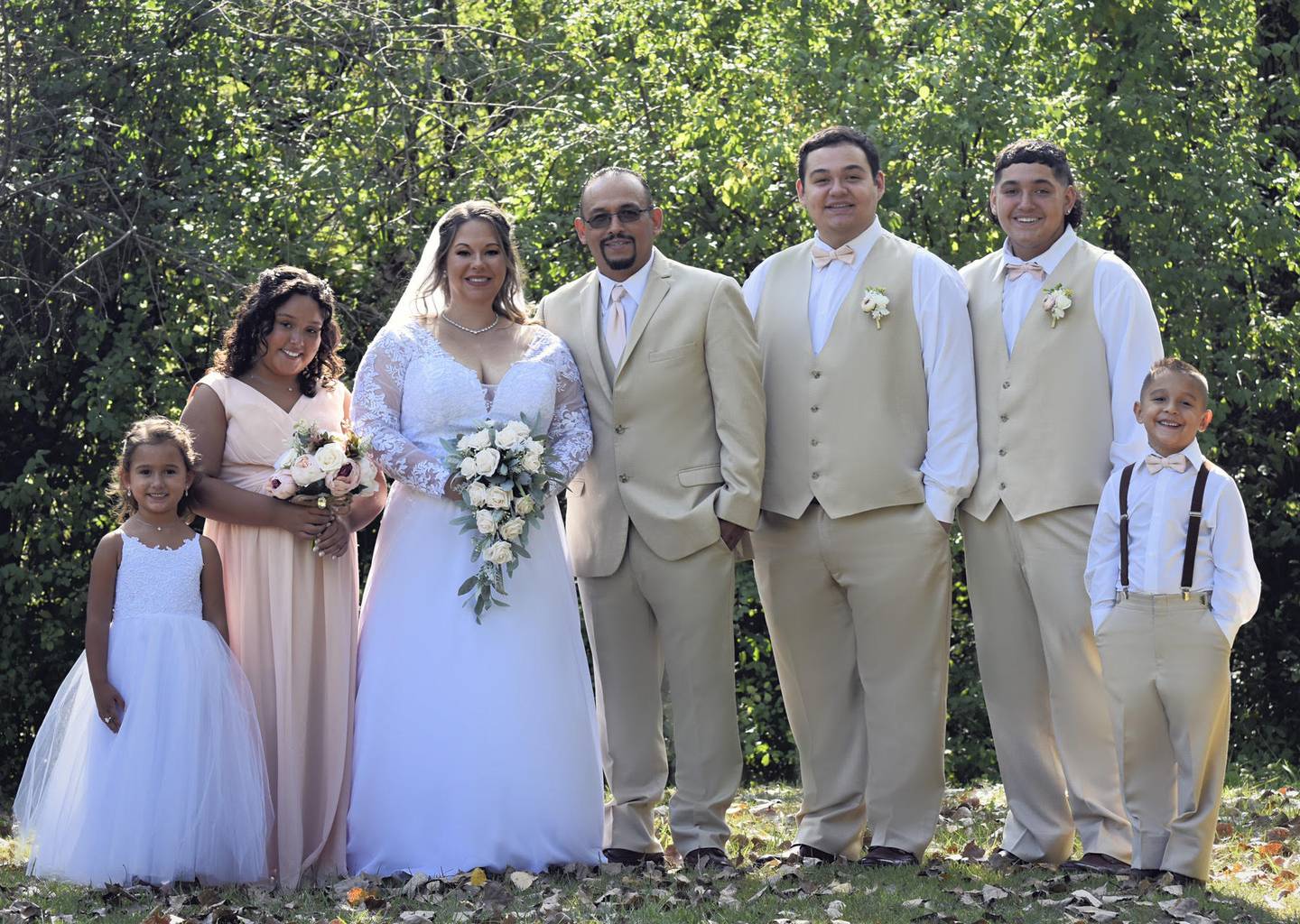 Kristin Glauner-Elizarraraz, third from left, and Cesar Mauricio Elizarraraz, fourth from left, at their September 2021 wedding in their backyard with their five children.