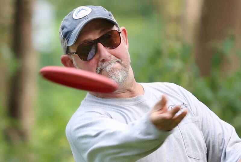 Kevin Schweitzer takes a shot Thursday, Sept. 2, 2022, at the new River Run Disc Golf Course in David Carroll Memorial Park in Genoa.