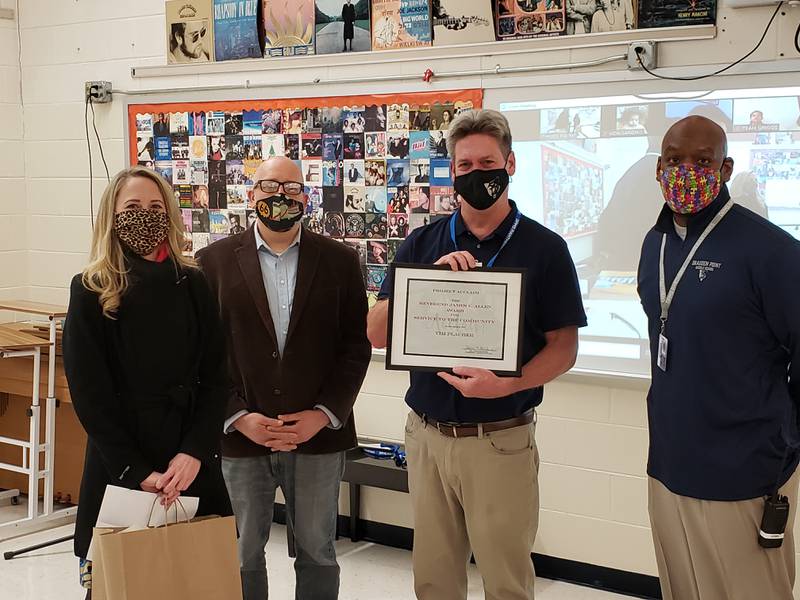 Project Acclaim President Jayne Bernhard (left), and member Quinn Adamowski presented the Rev. James E. Allen Award to Drauden Point Middle School music teacher Tim Placher to honor him for his passionate efforts to promote local music. Drauden Point Principal Kai Freeman (right) helped surprise Placher with the award.