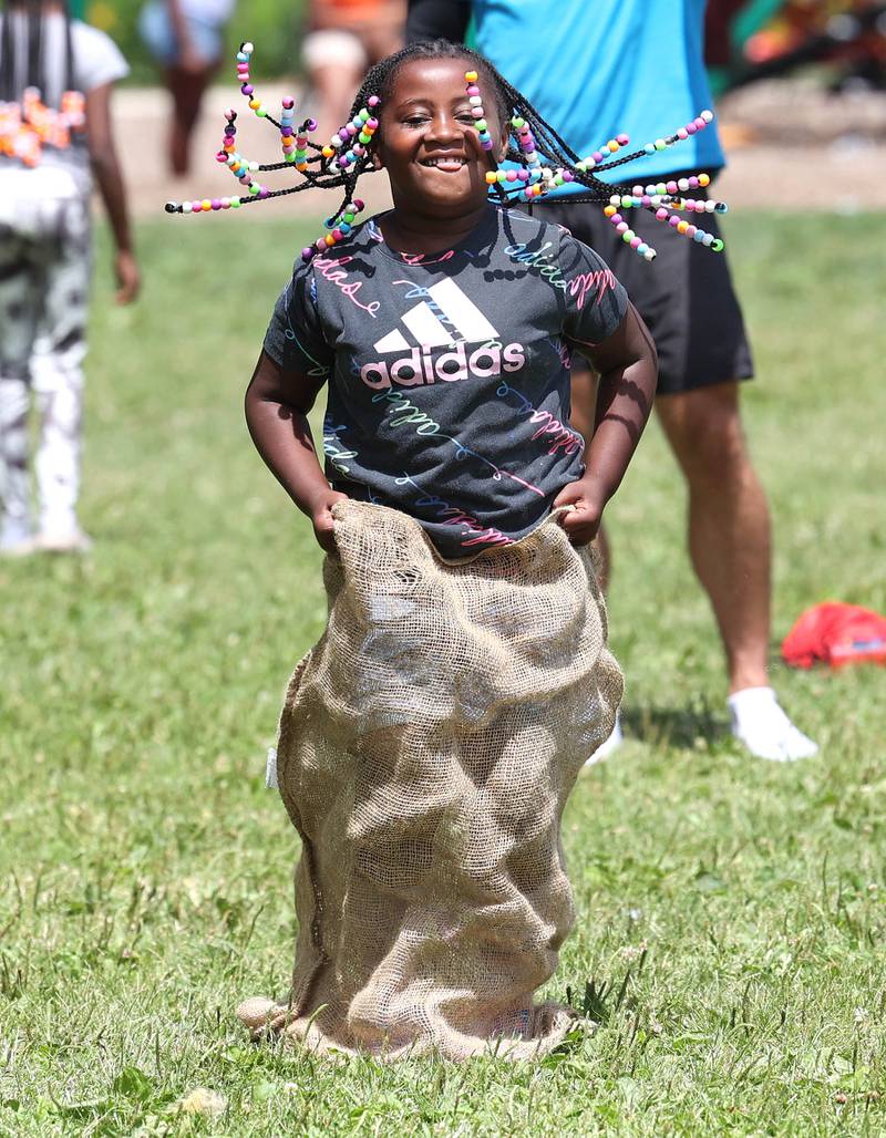Malania Sanders, 6, from DeKalb, participates in the sack race during Camp Power at Welsh Park in DeKalb. Camp Power, which is run by the Kishwaukee Valley YMCA, is a summer program for youth at University Village that provides positive activities for kids.