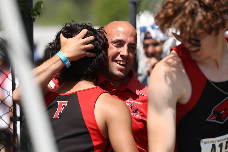 Forreston-Polo head coach Tony Hardin hugs his runners after they finished first place in the Class 1A 4x100 Relay State Finals on Saturday, May 27, 2023 in Charleston.