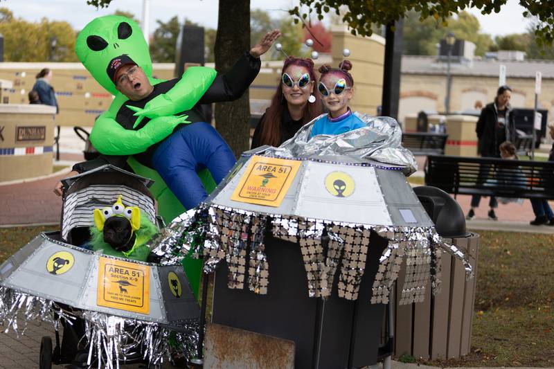 The Callison Family, of Warrenville, pose with their dog, Maisie, as they wait for a costume contest to begin at BatFest on Saturday, Oct. 25, 2025, in downtown Batavia.