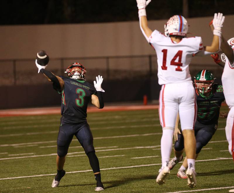 L-P's Rylynd Rynkewicz throws a pass down the field as Ottawa's Archer Cechowiz defends on Friday, Oct. 3, 2025 at Howard Fellows Stadium.