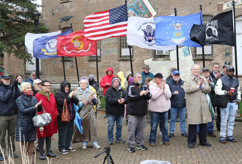 The gathered crowd of around 100 applaud a speaker Thursday, Nov. 11, 2021, during a Veterans Day and Soldiers' and Sailors' Memorial Clock rededication ceremony at Memorial Park in downtown DeKalb.