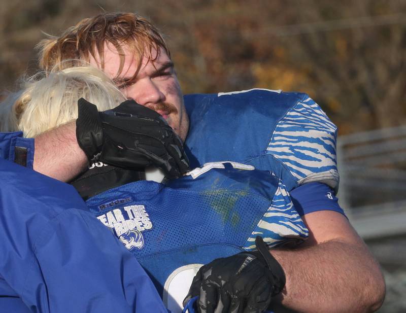 Princeton's Payne Miller hugs teammate Ian Morris after loosing to Montini Catholic on Saturday, Nov. 11, 2023 at Bryant Field in Princeton.