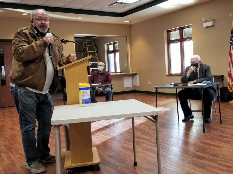 John Macrito, a candidate for McHenry Township trustee, criticizes the current board of trustees in public comments Friday. Board member Steve Verr, pictured, right, and Bob Anderson expressed concerns with an agenda item at an upcoming special meeting of voters that suggested the pay could be raised for elected offices.