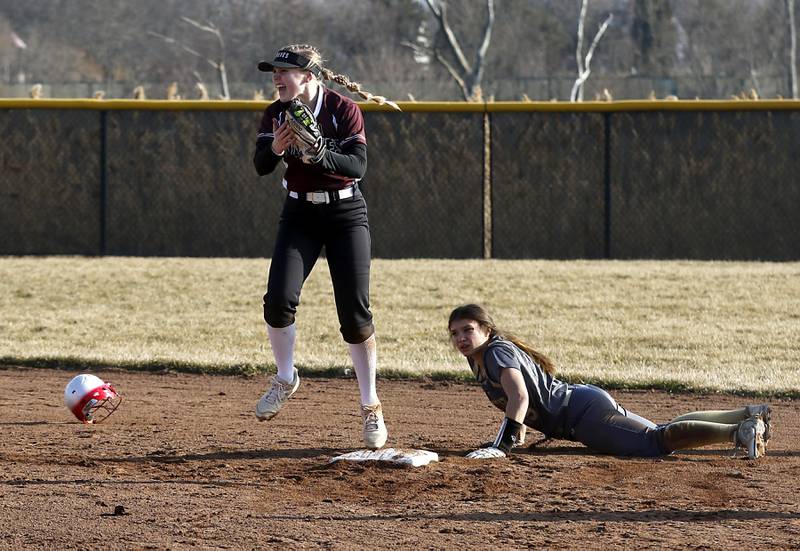 Prairie Ridge’s Adysen Kiddy reacts to tag out Grayslake North’s Madeline Von Allmen as she tries to steal second base during a nonconference softball game Thursday. March 23, 2023, at Grayslake North High School.