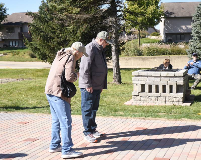 U.S. Arm veteran Rick Martha (right), who served during the Vietnam war, stands with his wife, Ruth Martha, as they look at bricks laid down to honor area veterans. The bricks sit at the base of the DeKalb Elks Veteran’s Memorial Plaza, dedicated during a ceremony in DeKalb Saturday, Oct. 1, 2022