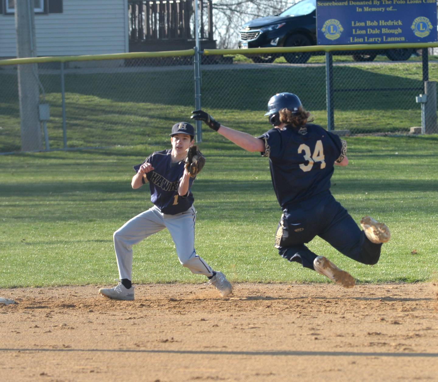 Polo's Scott Robertson tries to avoid the tag by Kirkland-Hiawatha's Aaron Jindrich during a March 28, 2024 at Westside Park in Polo. The Marcos went on to win the game 6-1.