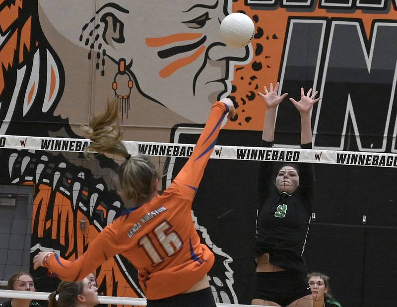 GK’s Alayna Pierce hits the ball while Rock Falls’ Cadence Williamson leaps up to try and block the shot.