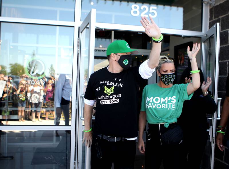 Donnie Wahlberg and Jennie McCarthy greet guests at the opening of Wahlburgers in St. Charles on July 28.