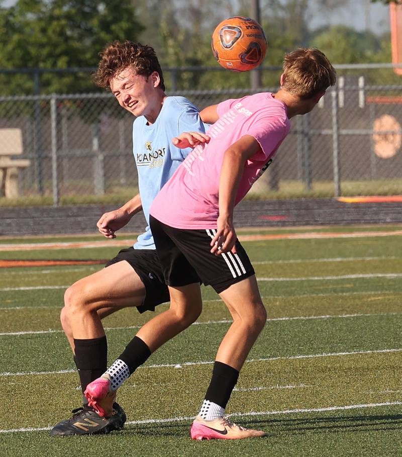 A Sycamore and DeKalb player go for a header Monday, July 14, 2025, during a summer boys soccer friendly at DeKalb High School.