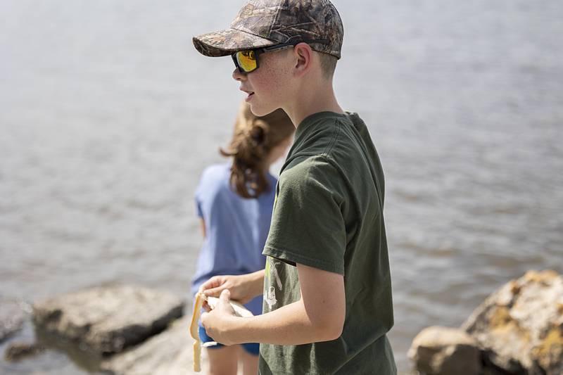 Grady Staats, 14, is using bread to fish for carp Tuesday, July 2, 2024 in Rock Falls.