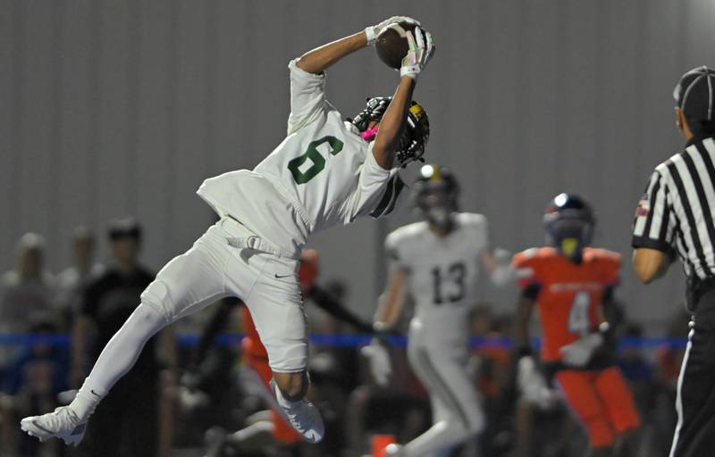 Fremd’s Jay Box catches a long touchdown pass in a football game in Hoffman Estates on Friday, Oct. 4, 2025 in downtown Arlington Heights.